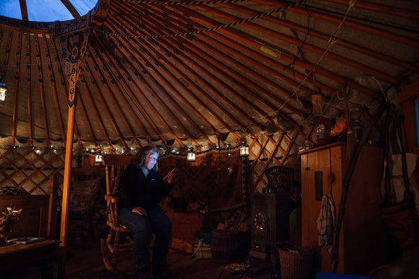 Francesca Cassini starts the fire in her Yurt near Llandinam, North Wales