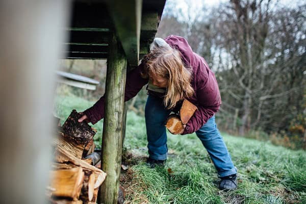 Francesca Cassini collects firewood for her yurt stove at Old Chapel Farm