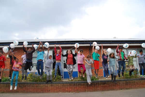 Children in Oxford celebrate the success of a community energy project. Image: Ethex