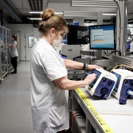 A medic inspects new ventilators