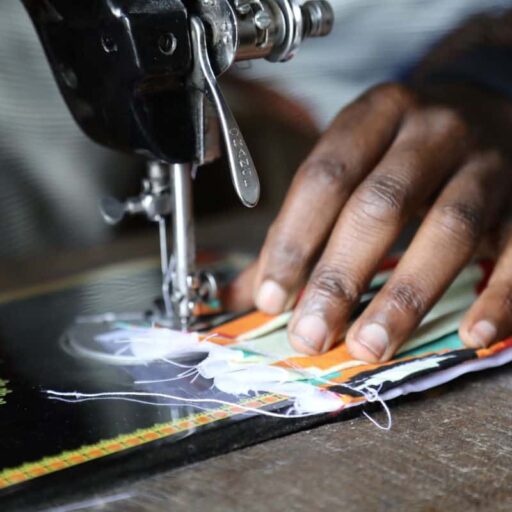 A tailor in Goma making a colourful face mask to halt the spread of coronavirus