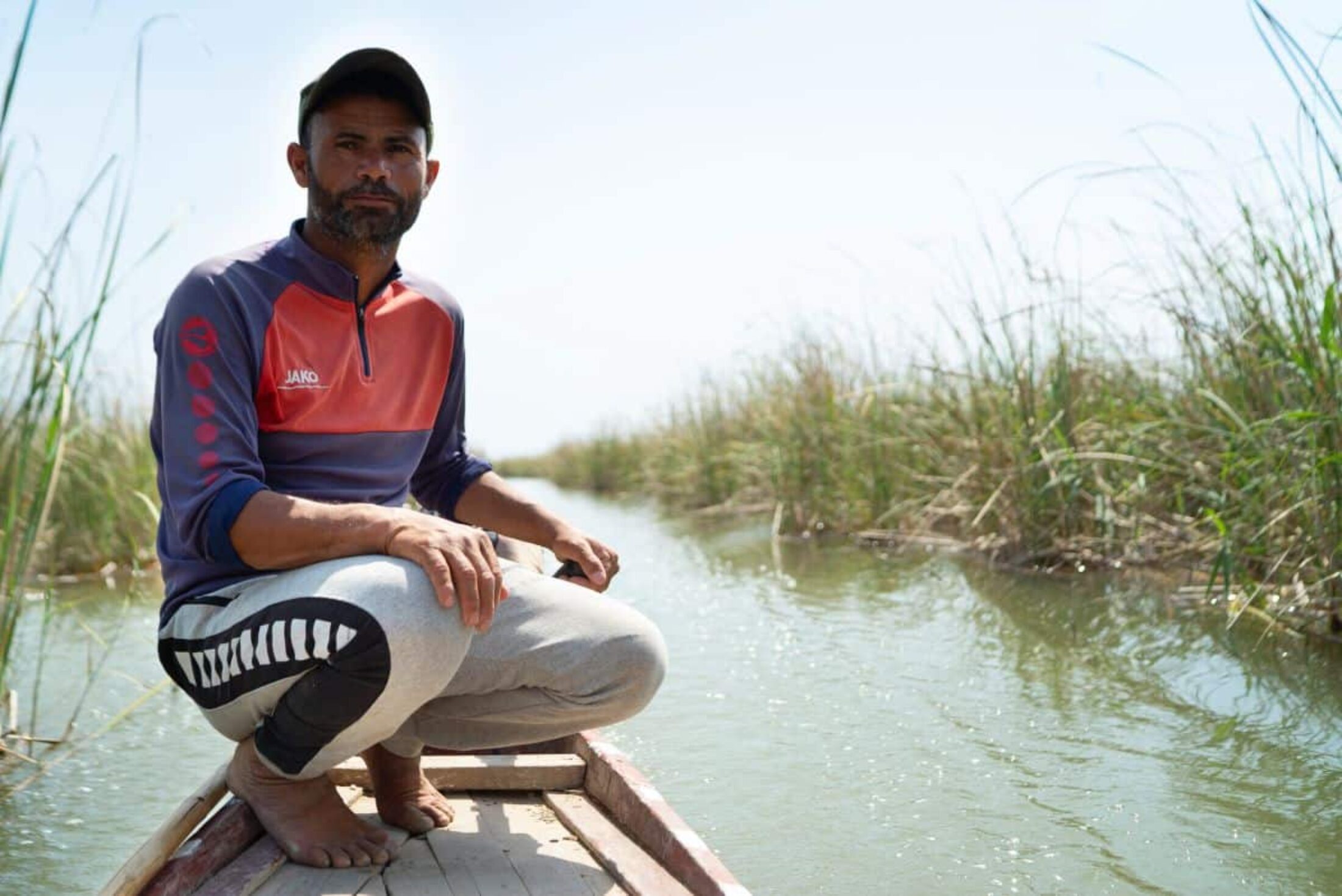 Razaq Nasser Saber steers his boat through reeds on the Mesopotamian Marshes