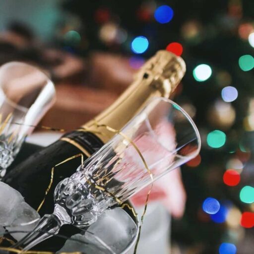 Champagne bottle in front of Christmas tree