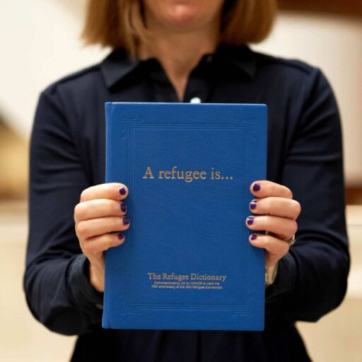 A woman holding the Refugee Dictionary