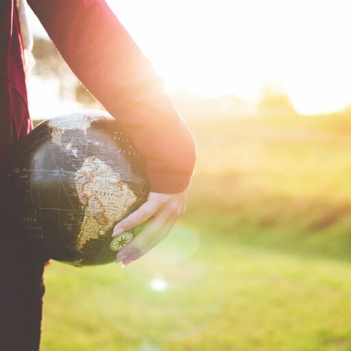 Person holding a globe